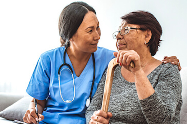 Image showing caregivers assisting residents with medication management and engaging in therapeutic activities, demonstrating how assisted living supports individuals in managing chronic conditions effectively.